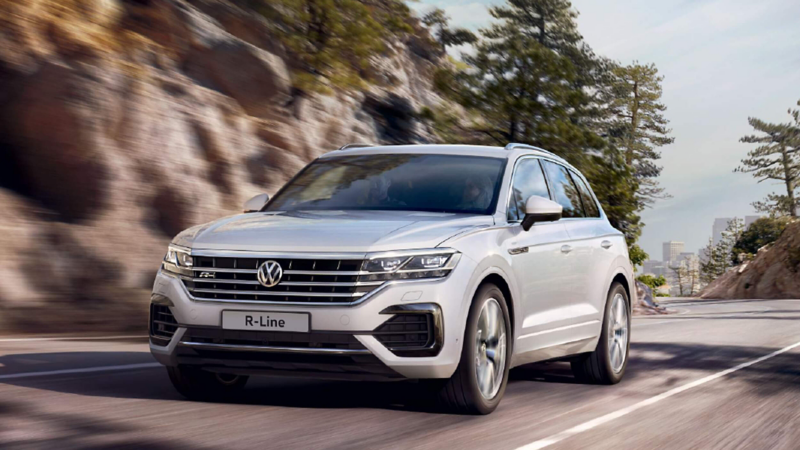 A silver coloured VW Touareg  being driven on a road