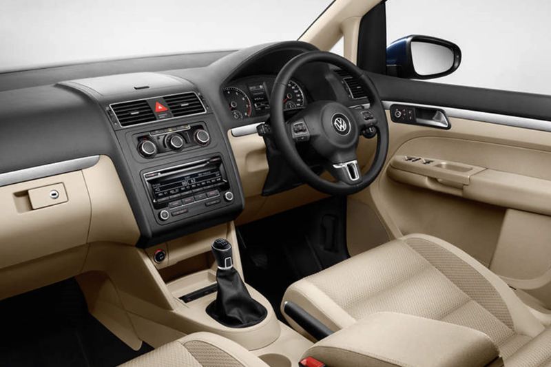 Interior shot of a Volkswagen Touran, steering wheel and dashboard.
