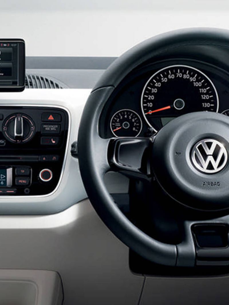 Interior shot of a Volkswagen up!, steering wheel and dashboard.