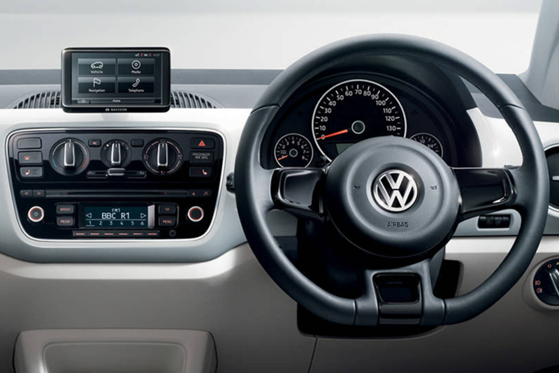 Interior shot of a Volkswagen up!, steering wheel and dashboard.