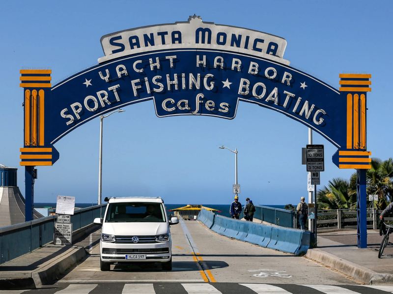 VW California parked on pier with historic signs