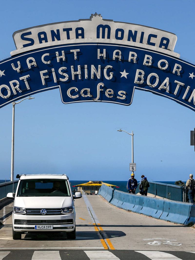 VW California parked on pier with historic signs