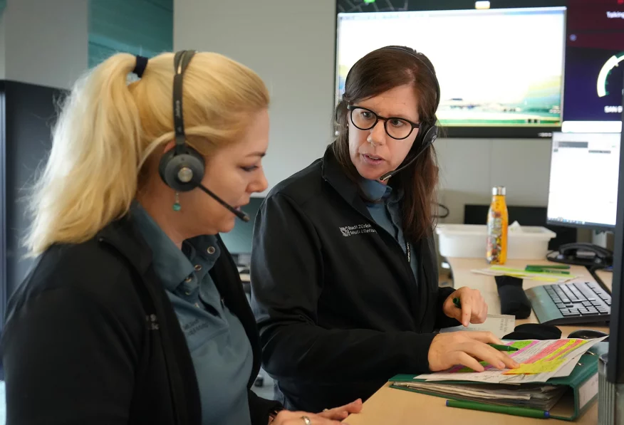Zwei Calltakerinnen besprechen einen Anruf. 