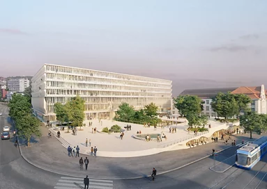 Ein heller, mehrgeschossiger, moderner Bau mit einem grosszügigen, stellenweise bepflanzten Vorplatz