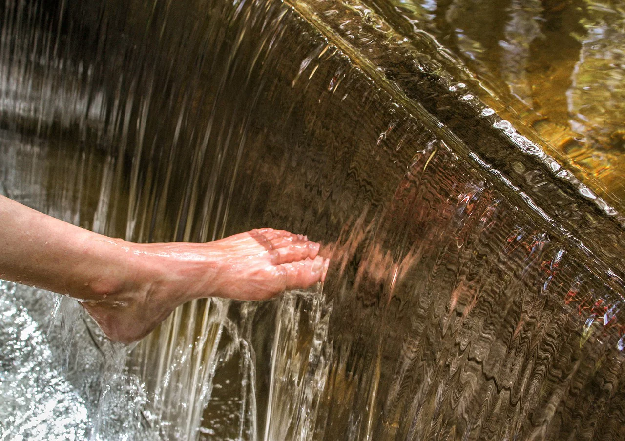 Fuss wird unter kühles Wasser gehalten