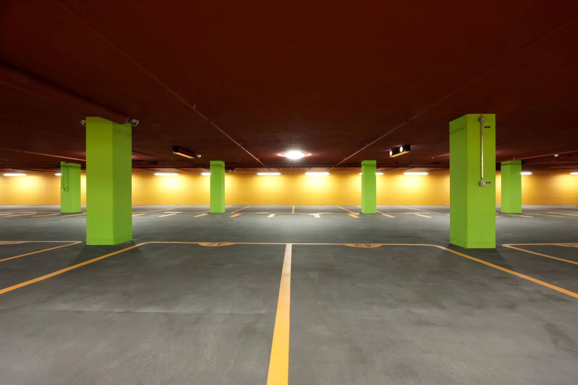 Parkhaus Dorflinde, grüne Säulen vor einer gelben Wand. Foto: Luca Zanier