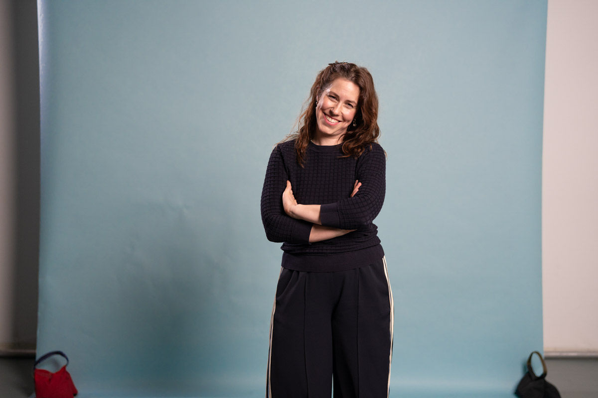 Frau steht mit verschränkten Armen 